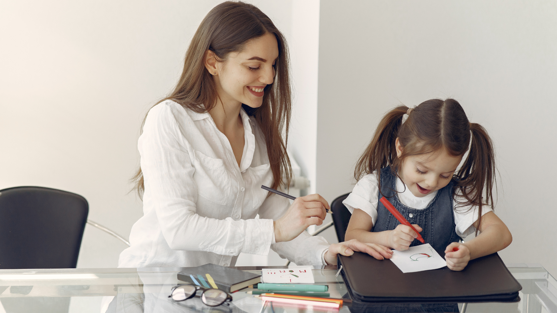 Young woman tutoring little girl 